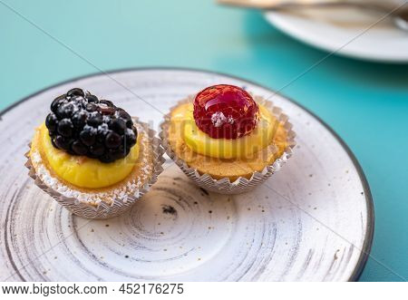 Mini Fruit Italian Cupcakes With Fresh Berries On Board