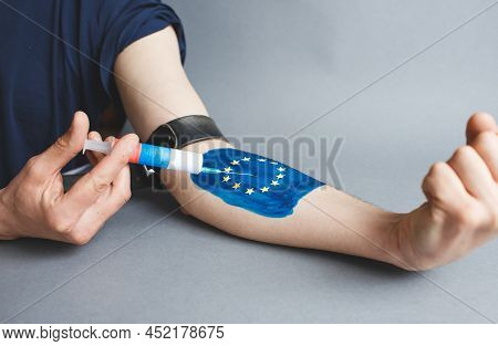A Drug Addict With An Image Of The European Flag On His Arm Makes An Injection With Russian Gas. Dep