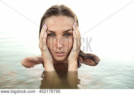 A Large Portrait Of A Woman Shot On The Surface Of Water. Born Again. Meaning Of Being