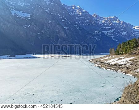 Frozen Klöntalersee Or Klontaler Lake During Early Spring In The Alpine Valley Klöntal (kloental Or 