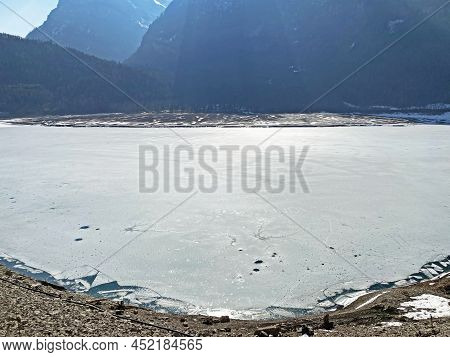 Frozen Klöntalersee Or Klontaler Lake During Early Spring In The Alpine Valley Klöntal (kloental Or 