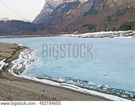 Frozen Klöntalersee Or Klontaler Lake During Early Spring In The Alpine Valley Klöntal (kloental Or 
