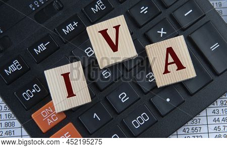 Iva (individual Voluntary Arrangement) - Acronym On Wooden Cubes On The Background Of A Calculator. 