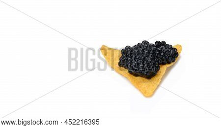 Triangular Nachos With Black Paddlefish Caviar Isolated On White Background. Snack, Copy Space
