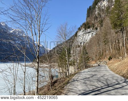 Paved Road By The Alpine Resevoir Lake Klöntalersee (kloentalersee Or Klontaler Lake) And In The Klö