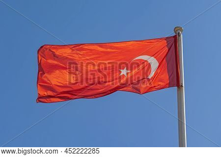 New Bright Red Flag Of Turkey At Clear Blue Sky Sunny Day