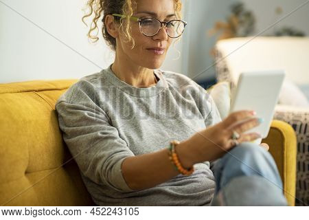 Close Up Potrait Of Modern Woman Female Adult People Reading Book From Electronic Reader Device Tabl