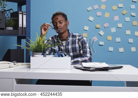 Upset Dissapointed Office Worker Packing Personal Belongings Because Of Job Dismissal. Depressed Man