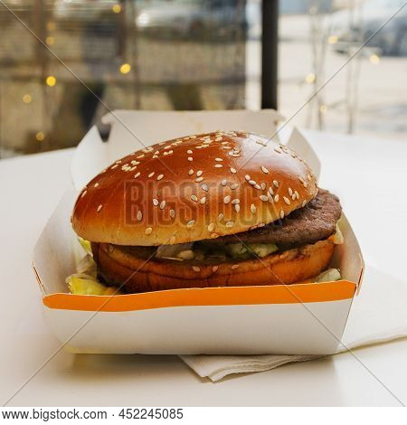 Sandwich With Bun, Steak And Vegetables In A Cardboard Box.