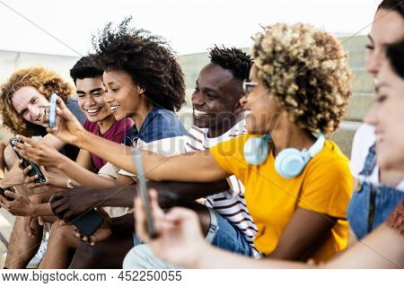 Young Group Of Multiracial People Using Smartphone Outdoors - Addicted Milllennial Friends Sharing S