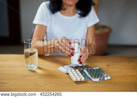 Mature Sick Woman Having Antibiotic, Aspirin Pills From Bottle From Flu