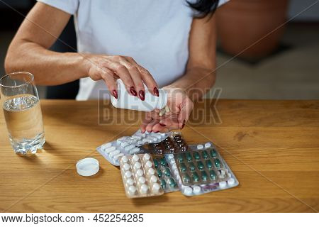 Mature Sick Woman Having Antibiotic, Aspirin Pills From Bottle From Flu