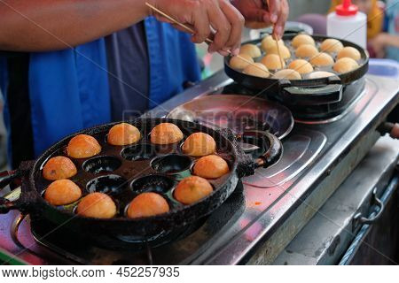 Takoyaki Is Being Cooked On A Frying Pan. Takoyaki Making Process