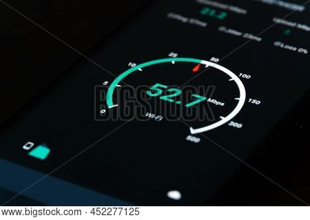 Close-up Of The Result Of Checking The Internet Speed On A Mobile Phone On A Black Background