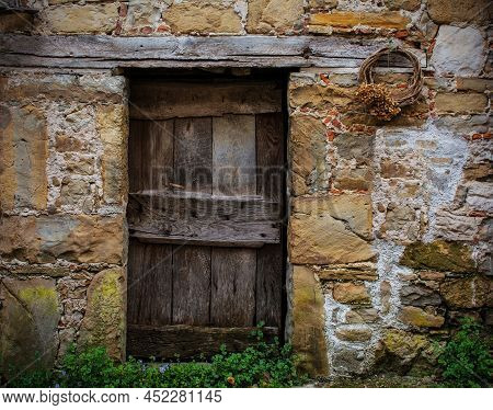 An Old Wooden Door In A Derelict House In Poffabro, An Historic Medieval Village In The Val Colvera 