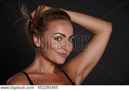 Attractive Middle Aged European Woman Cutely Smiles Looking At Camera Isolated Over Black Background