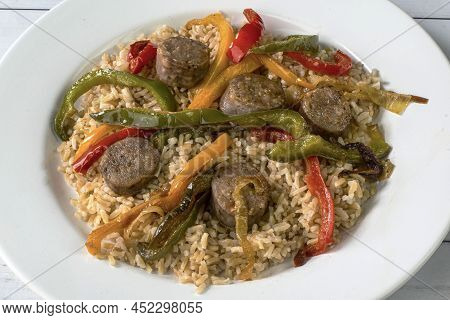 Brown Rice With Sauteed Onions And Peppers Top Witr Sausages
