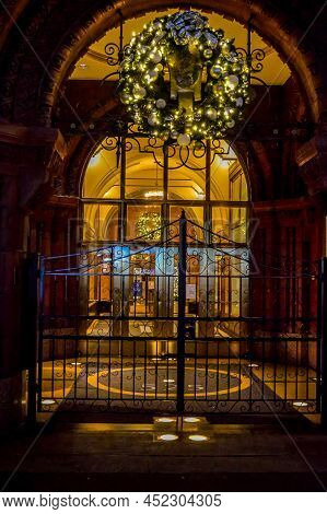 A Black Gate In Front Of An Old Vintage Doorway In Midtown Manhattan.night Shot.