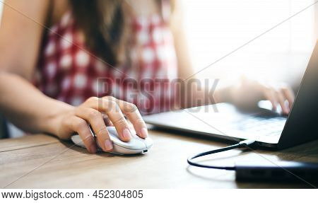 Focus In Hand Young Asian Woman In Casual Clothes Holding Computer Mouse While She Working Or Study 