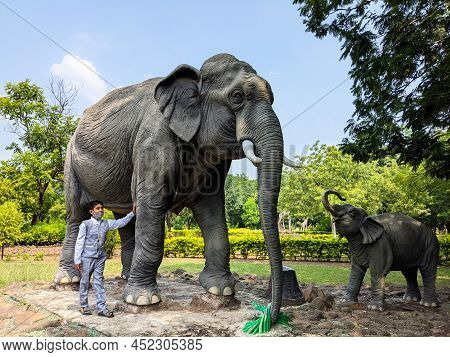 Beautiful Long View Of Boy With Elephants Family Sculptures Isolated In Gulbarga University Garden: 