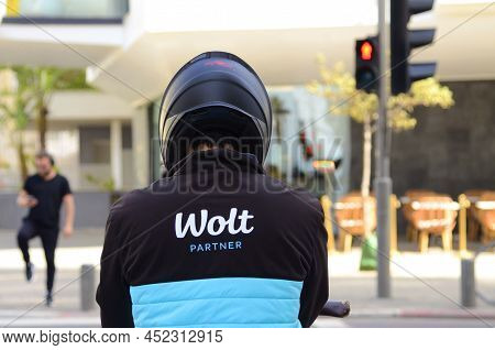 17.03.2022 Tel Aviv. Israel - Food Delivery Wolt. Delivery Courier - Back At Crosswalk. Close-up Bra