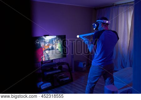 Man With Virtual Reality Headset And Joystic Is Playing Game