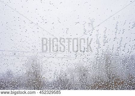 Abstract Blurred Background Of Wet Snow On The Window, Horizontal