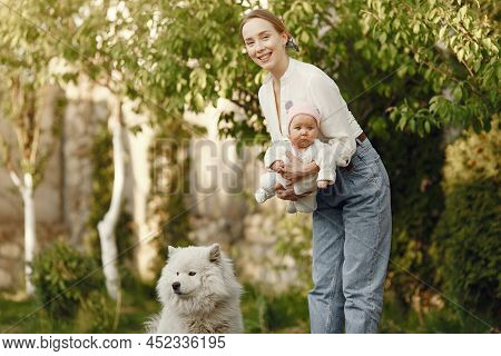 Family Spend Time In A Summer Garden