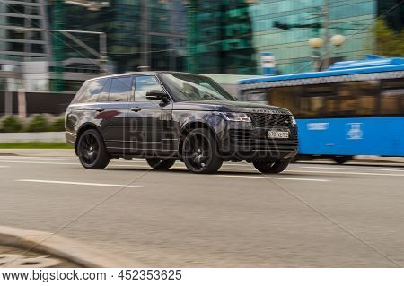 Range Rover L405 Car Moving In City Street On High Speed. Fast Moving Luxury Suv Car On The Speedway