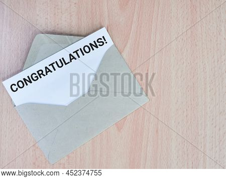 Phrase Congratulation Written On  White Paper Inside Envelope.