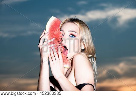 Sexy Young Woman Lick Watermelon With Sexy Tongue. Closeup Portrait Of Young Blonde Sensual Woman Ea