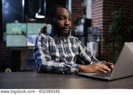Hedge Fund Company Trader Using Laptop To Predict Forex Stock Market Trend And To Analyze Real Time 