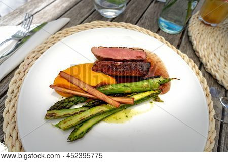 Plate Of Duck Breast Asparagus And Sweet Potato Puree In A Fine Dining Restaurant