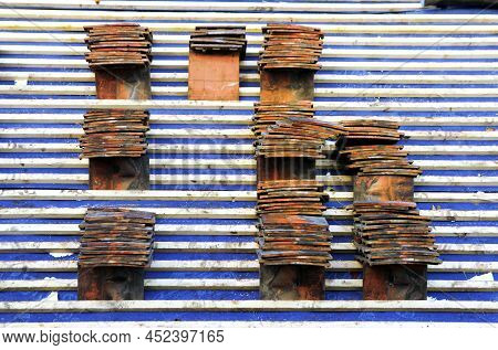 Roof Tiles In Piles On A Roof Ready To Be Laid On The Battens By A Roofing Contractor.