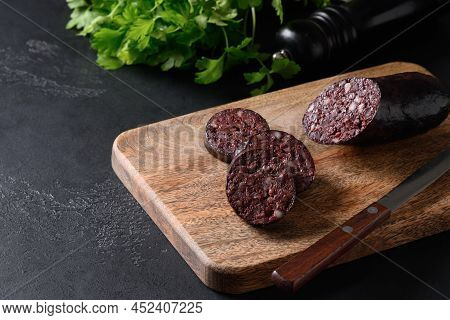 Morcilla Blood Sausage On Wooden Tray On Black Background. Close Up.