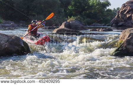 A Man Rowing Inflatable Packraft On Whitewater Of Mountain River. Concept: Summer Extreme Water Spor