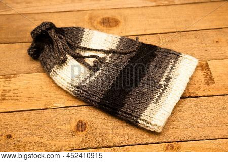 Handmade Wool Knitted Winter Gray And Whitehat Isolated On Wooden Background