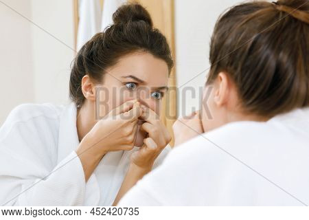 Young Woman Squeeze Pimples In The Bathroom