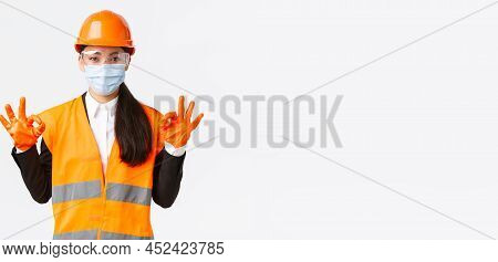 Covid-19 Safety Protocol At Enterpise, Construction And Preventing Virus Concept. Satisfied Asian Fe
