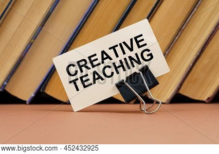 Education And Science Concept. On The Table Against The Background Of Books Is A Business Card With 
