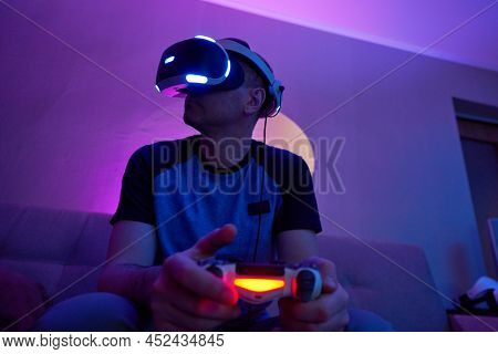 Man With Virtual Reality Headset And Joystic Is Playing Game