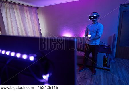 Man With Virtual Reality Headset And Joystic Is Playing Game