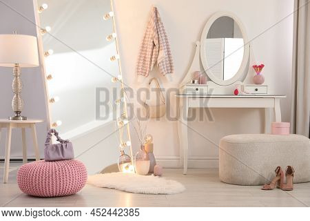 Large Mirror With Light Bulbs And Dressing Table In Stylish Room. Interior Design