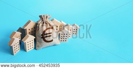 Euro Money Bag Surrounded By Houses. Buying Apartments. Real Estate Investment. Mortgage Loan. Budge