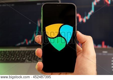 Nem Xem Cryptocurrency Logo On The Screen Of A Smartphone In Mans Hand With A Growing Trend On The C