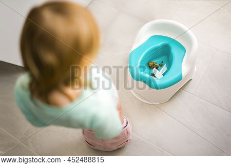 Cute Child Girl Is Looking Chamberpot Poo On The Bathroom