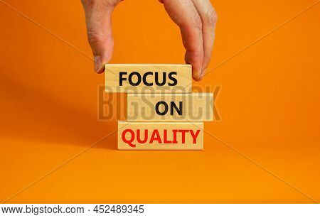 Focus On Quality Symbol. Concept Words Focus On Quality On Blocks On Beautiful Orange Table Orange B