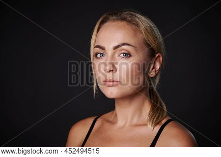 Beautiful Gorgeous 30s Young Caucasian Blonde Woman Looking At Camera Isolated On Black. Close-up Be