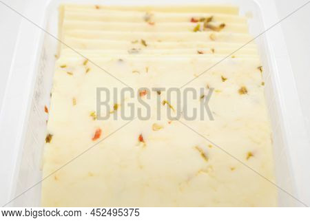 Pepper Jack Cheese Slices Isolated Over a White Background