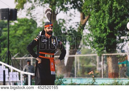 Wagah Border, Pakistan - July 22, 2021: Brave Pakistan Soldiers In Bright Military Uniform Marching 